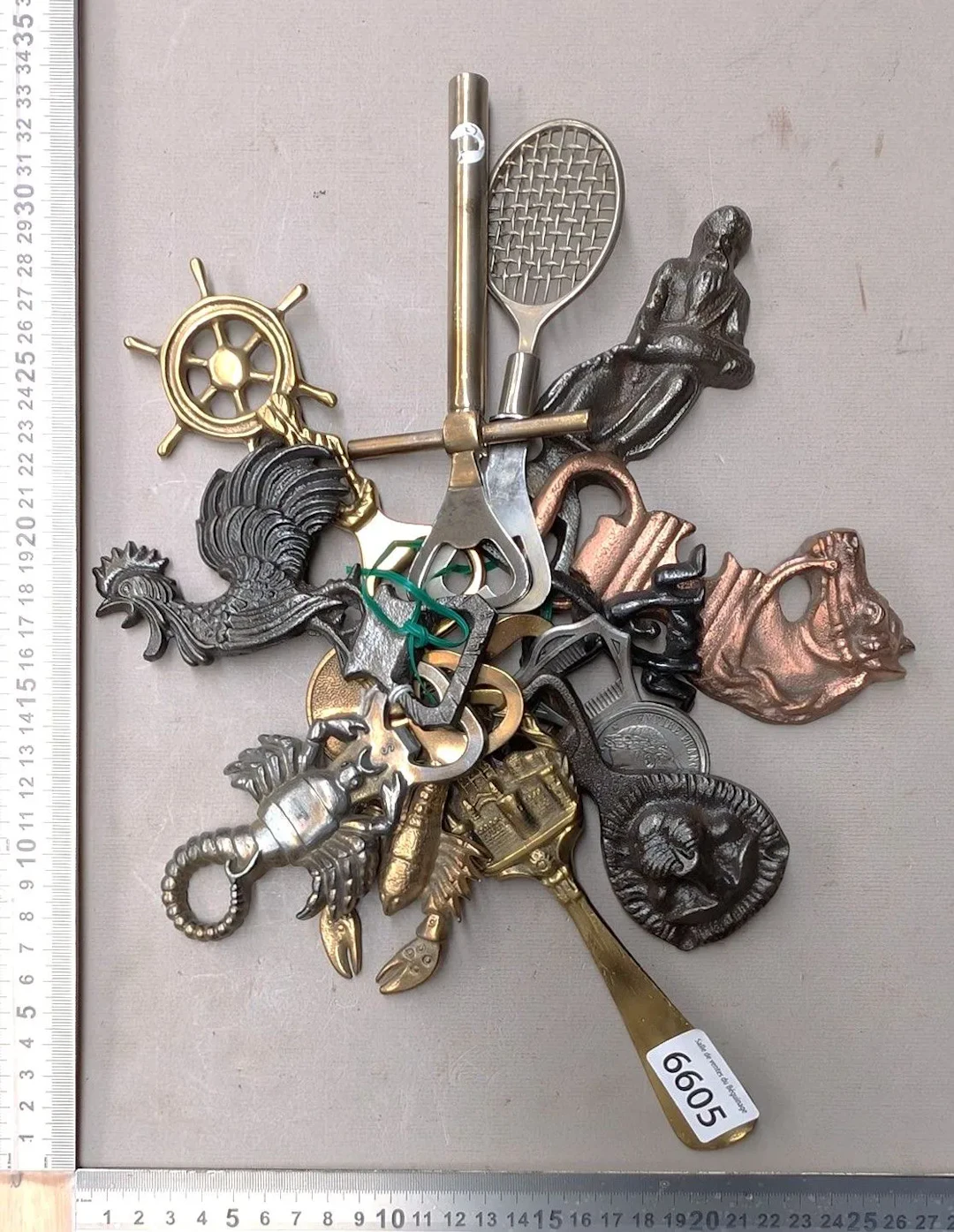 13 antique bottle openers—see photos for dimensions and condition