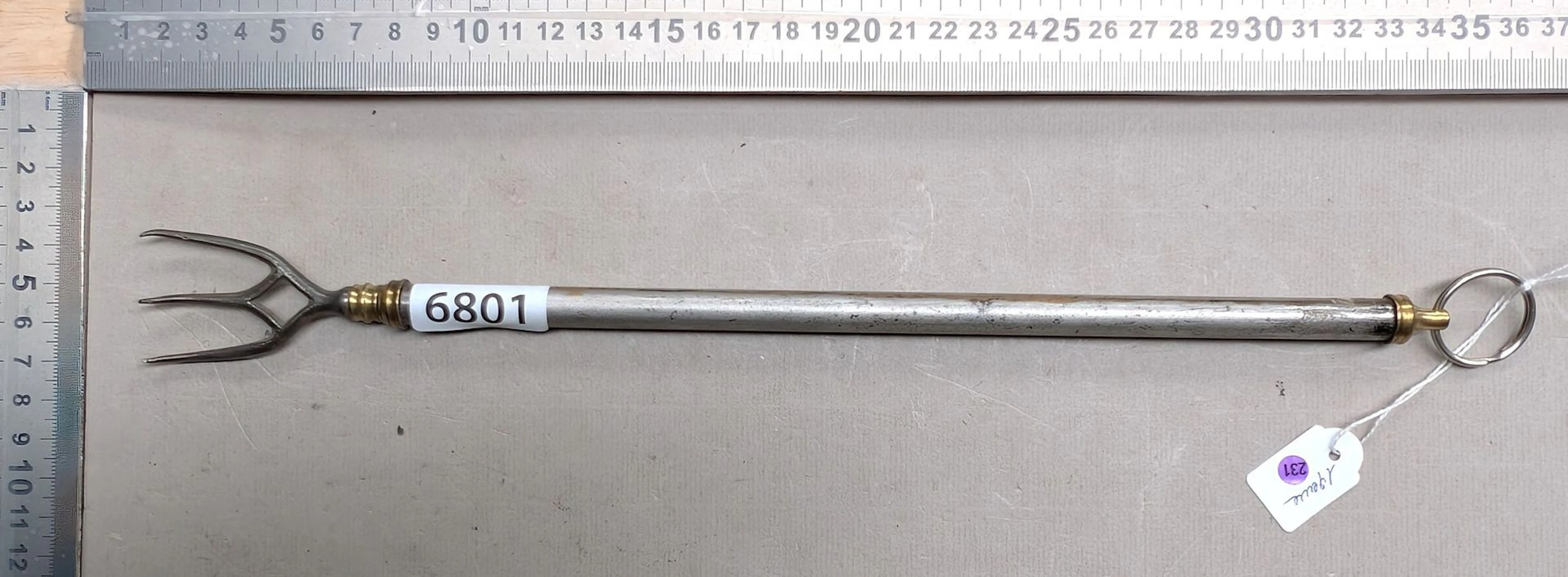 1 telescoping copper and steel fireplace fork from the 19th century—see