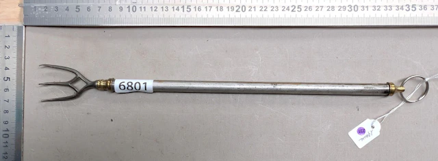 1 telescoping copper and steel fireplace fork from the 19th century—see