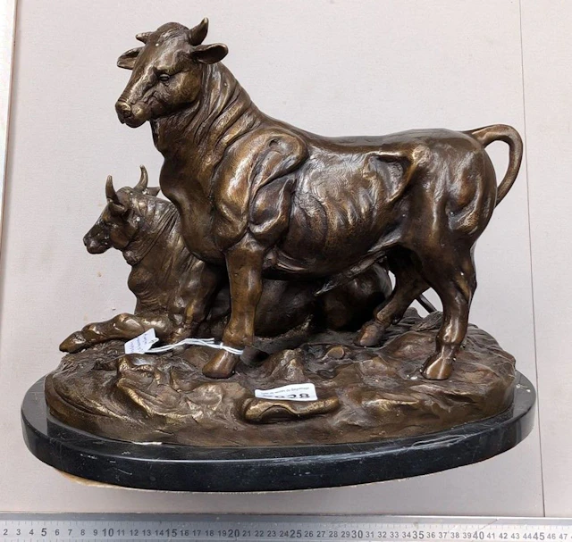 A bronze bull sculpture—see photos for dimensions and condition