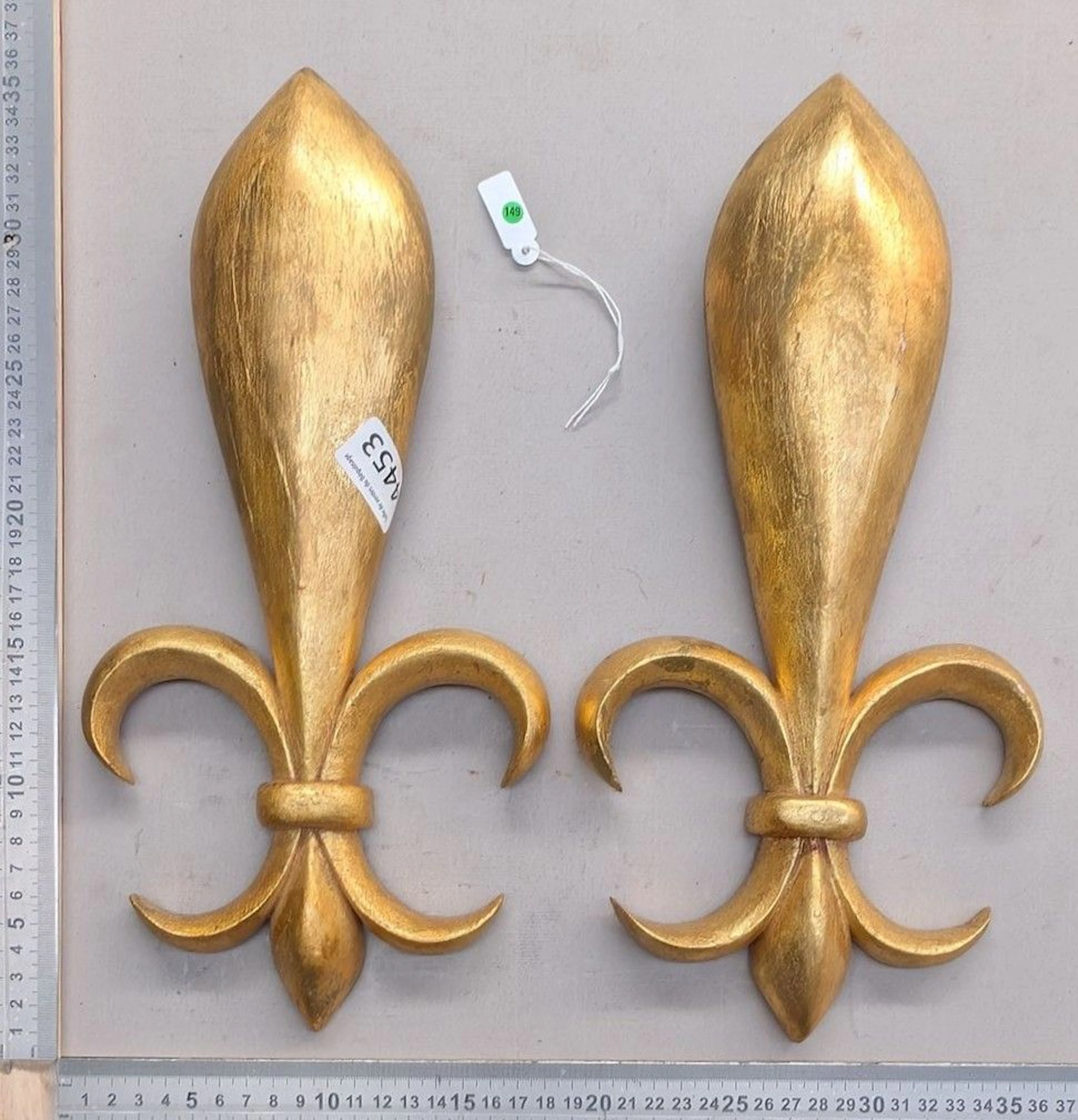 Two fleurs-de-lis, made of gilded wood—see photos for dimensions and condition