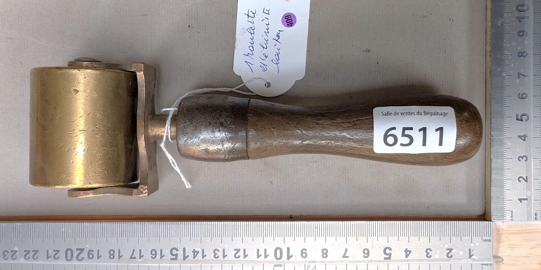 1 brass cabinetmaker's caster with a wooden handle—see photos for