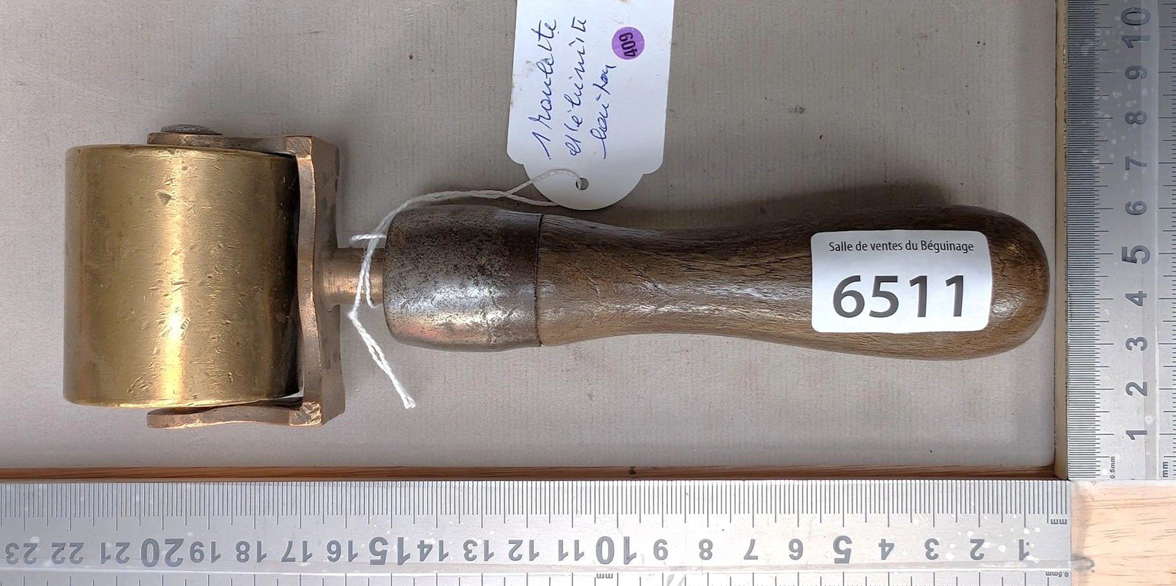 1 brass cabinetmaker's caster with a wooden handle—see photos for