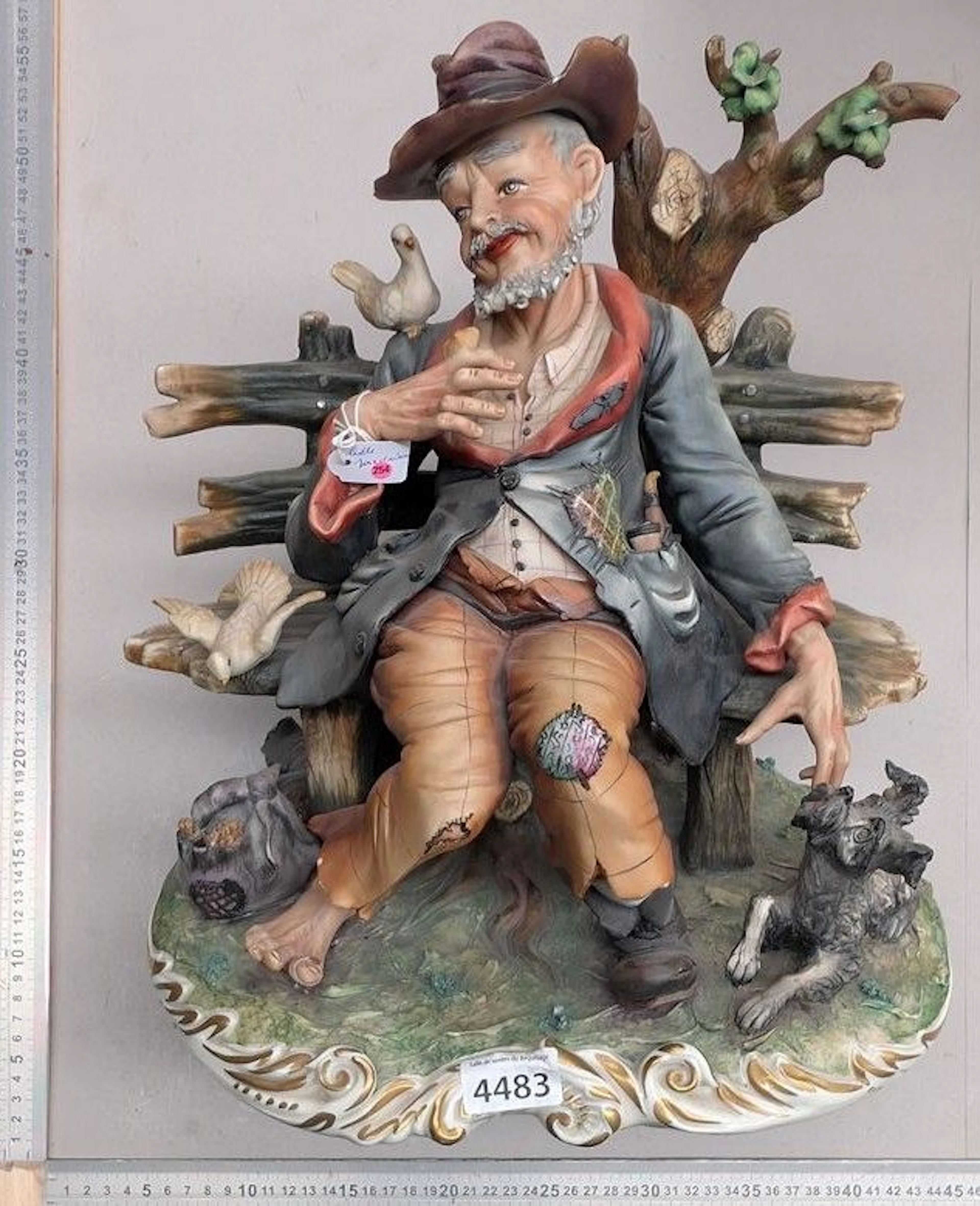 Porcelain, man feeding birds—see photos for dimensions and condition