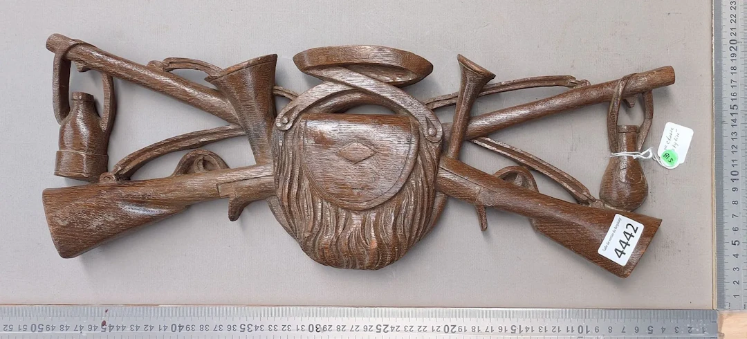 Decorative wooden sculpture depicting a stylized hunting trophy -