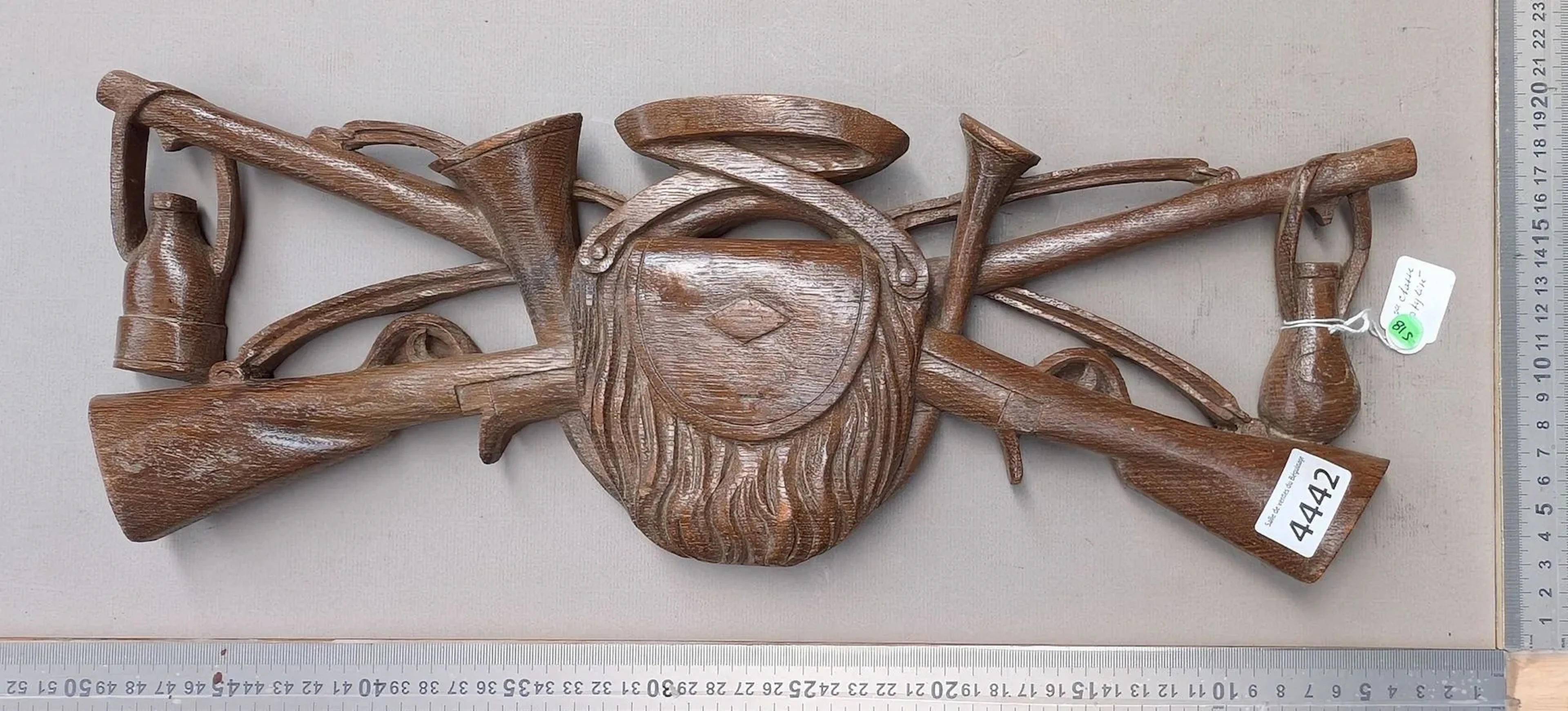 Decorative wooden sculpture depicting a stylized hunting trophy -