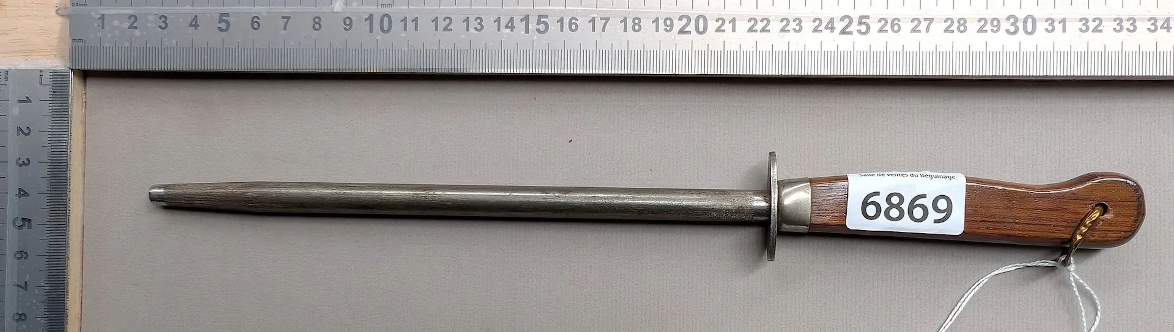 Antique butcher's sharpening knife with wooden handle, 20th century—see