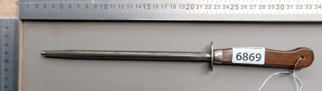 Antique butcher's sharpening knife with wooden handle, 20th century—see