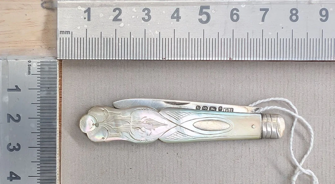 1 antique fruit knife with a silver blade and mother-of-pearl handle—see