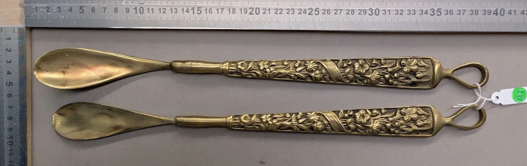 A pair of brass shoehorns—see photos for dimensions and condition