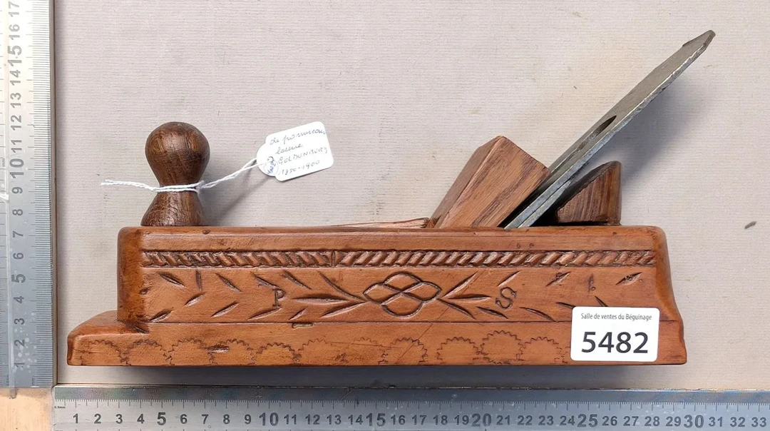 Antique, richly decorated wooden plane with a pommel-shaped handle