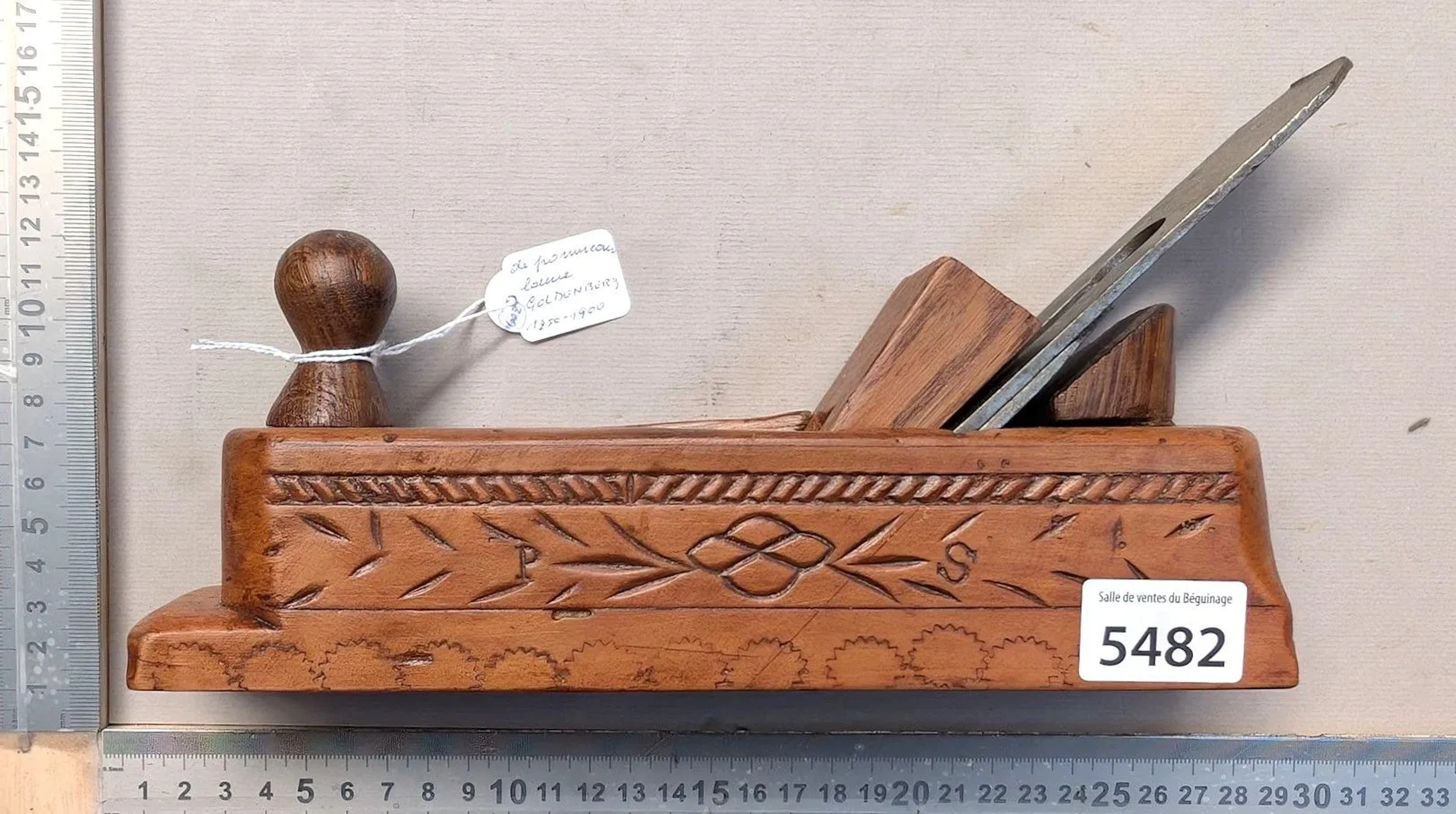 Antique, richly decorated wooden plane with a pommel-shaped handle