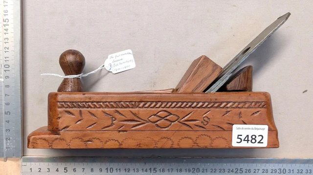 Antique, richly decorated wooden plane with a pommel-shaped handle