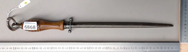 Antique butcher's sharpening knife with wooden handle, 20th century—see