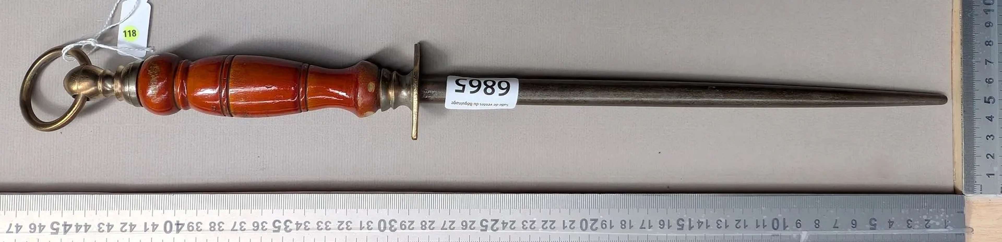 Antique butcher's sharpening knife with wooden handle, 20th century—see