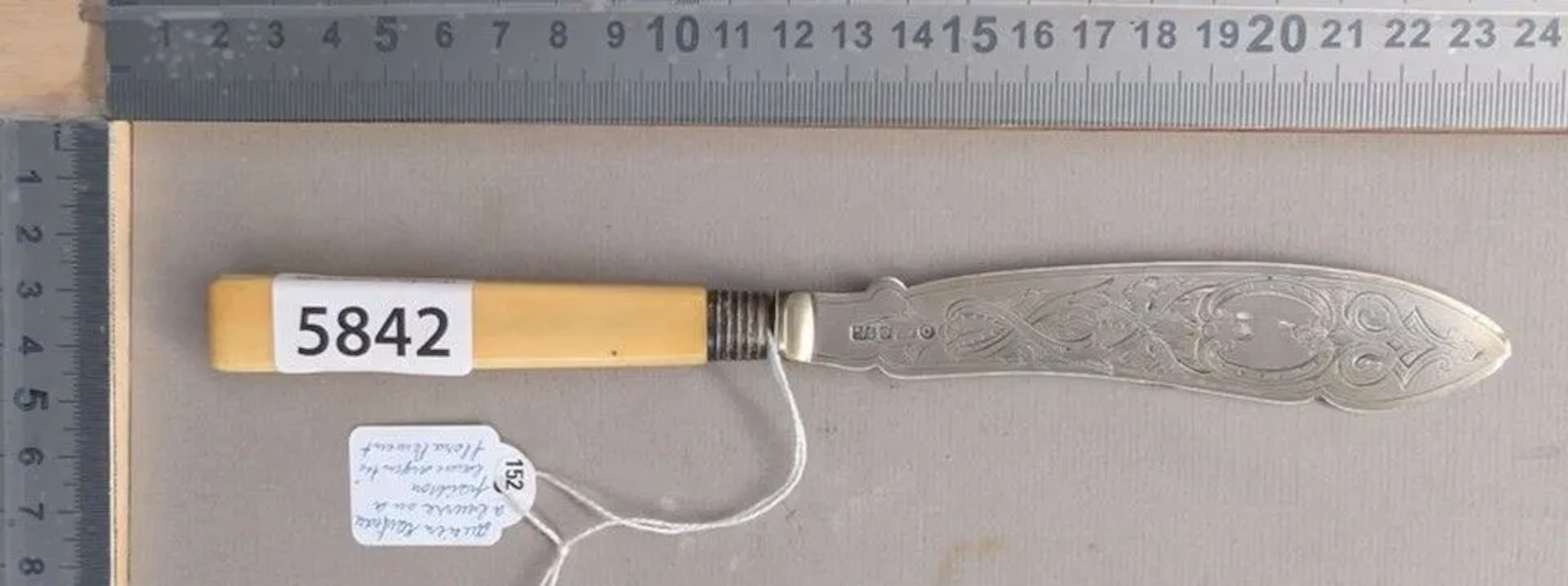 Antique silver butter or fish knife with floral design and hallmark—see