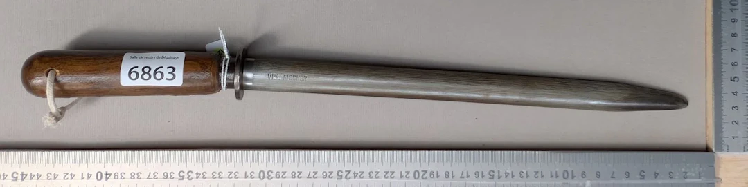 Antique butcher's sharpening knife with wooden handle, 20th century—see