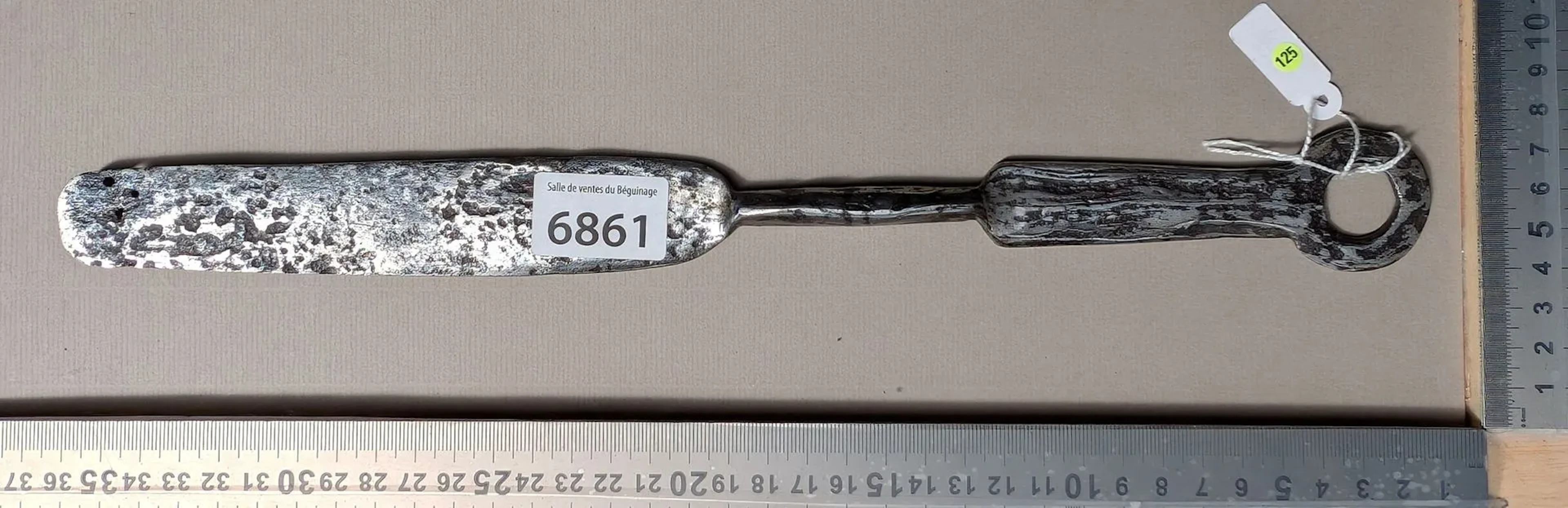 Antique butcher's sharpening knife with steel handle, 20th century—see