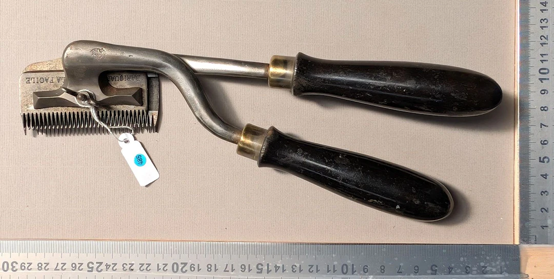 1 vintage mechanical lawn mower with a wooden handle—see photos for