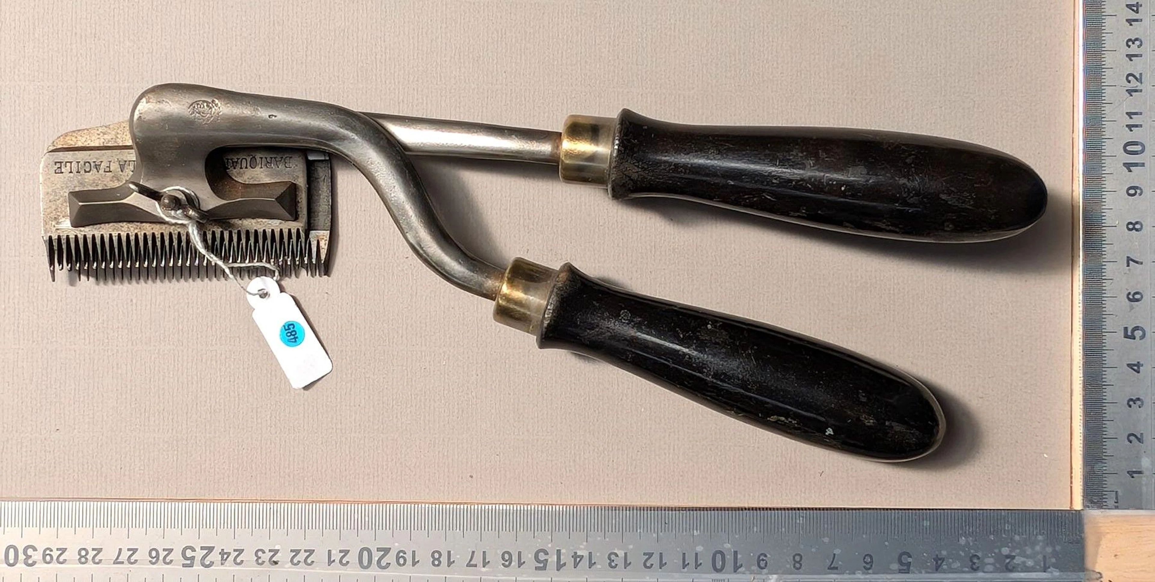1 vintage mechanical lawn mower with a wooden handle—see photos for