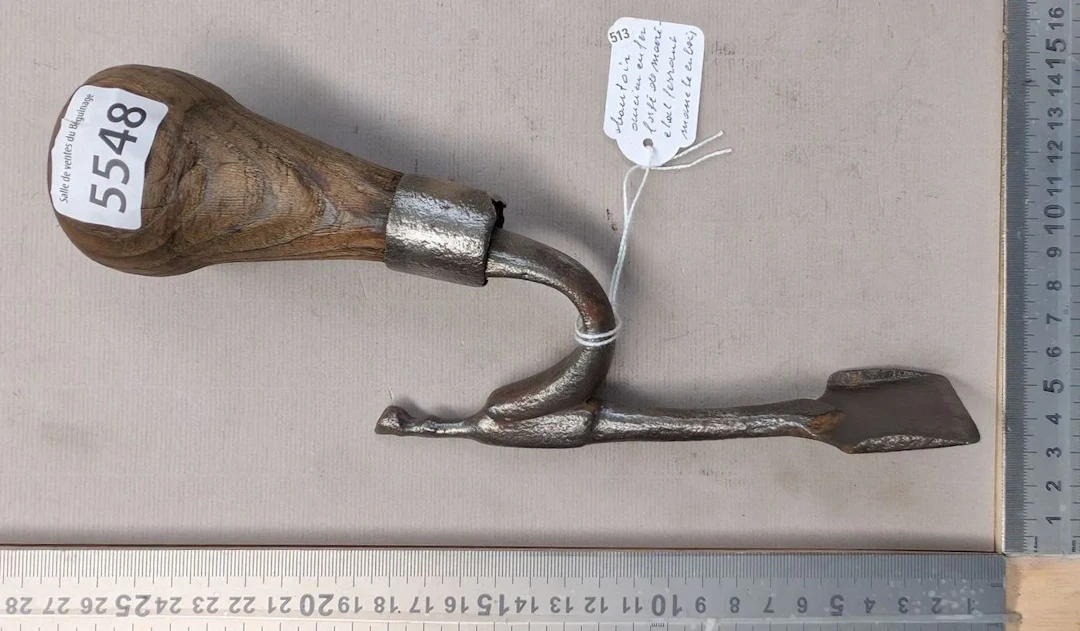 Antique wrought-iron rammer with a farrier's wooden handle—see photos