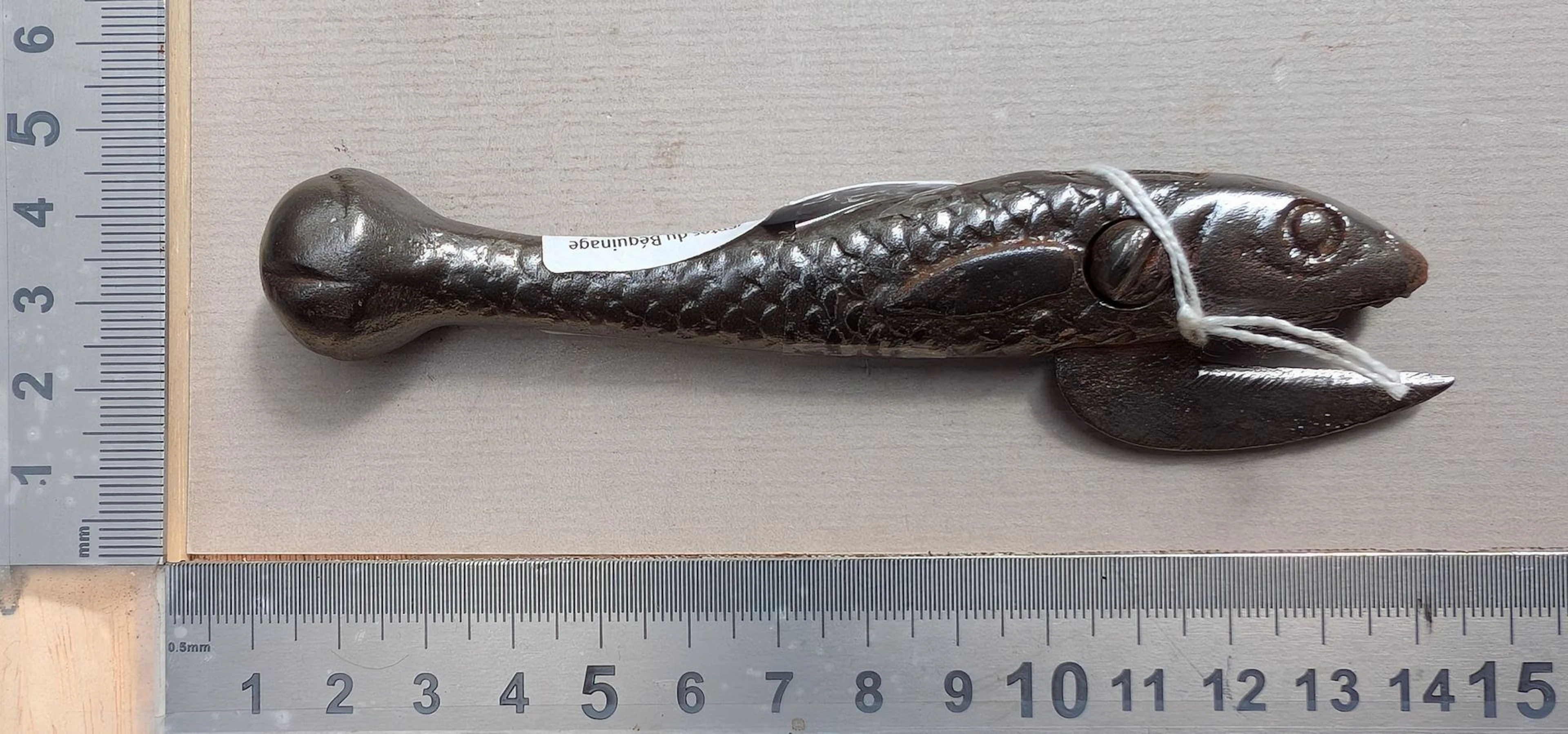 1 antique cast-iron can opener shaped like a fish—see photos for dimensions