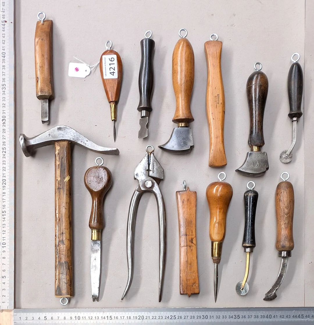15 shoemaker's and saddler's tools on an oak base—see photos for dimensions
