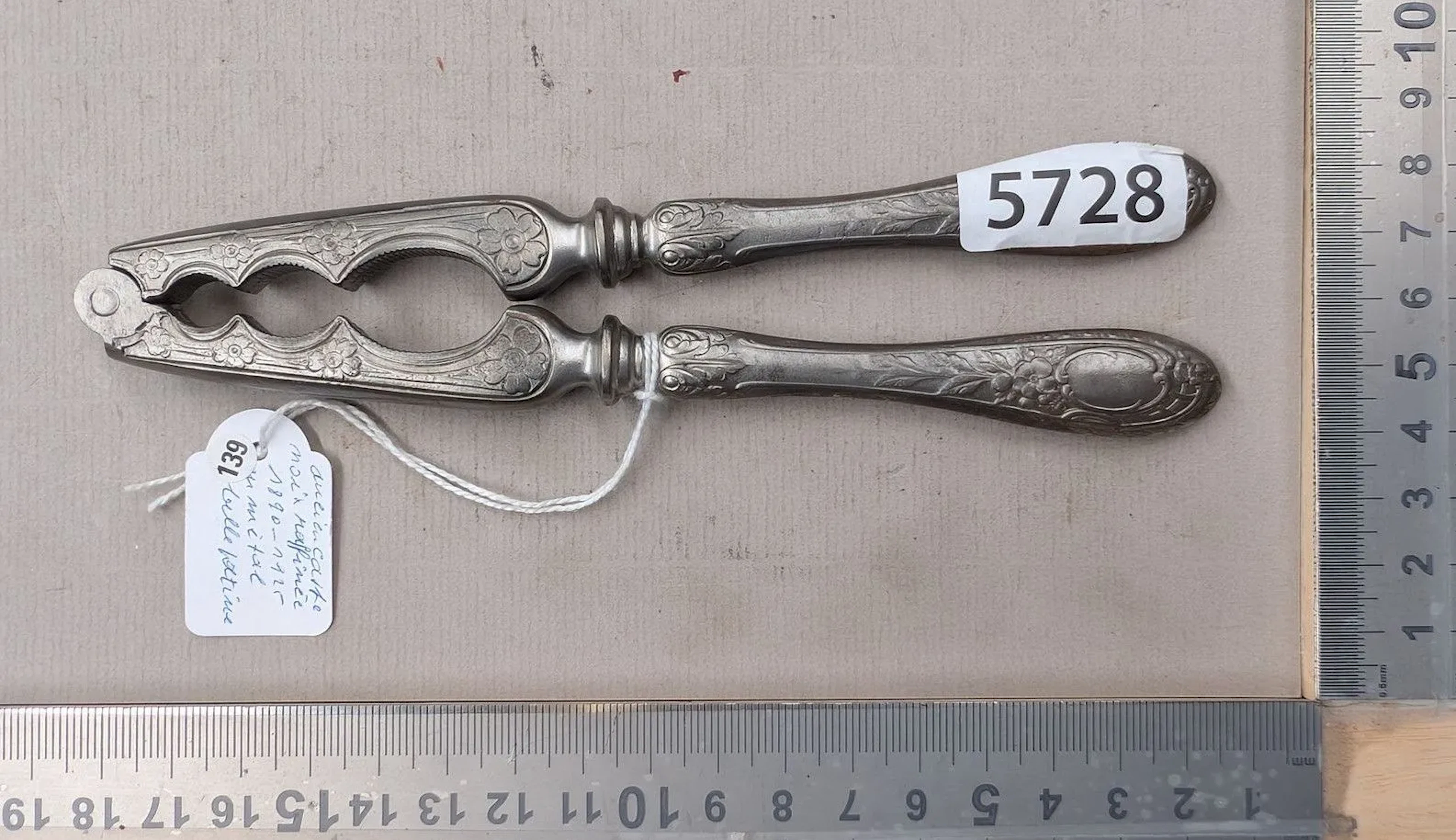 An antique nutcracker, made of refined metal, with a beautiful patina