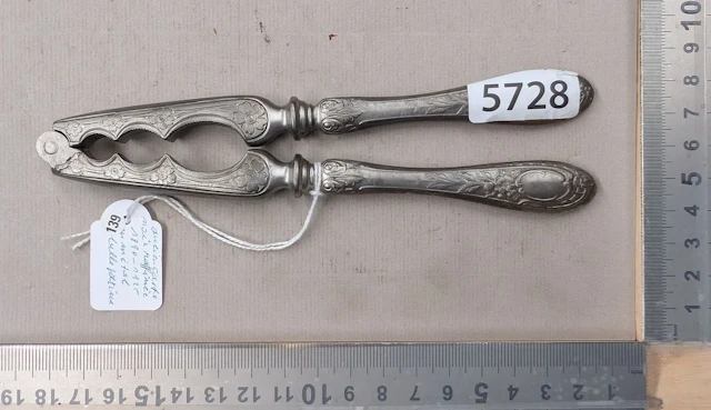 An antique nutcracker, made of refined metal, with a beautiful patina