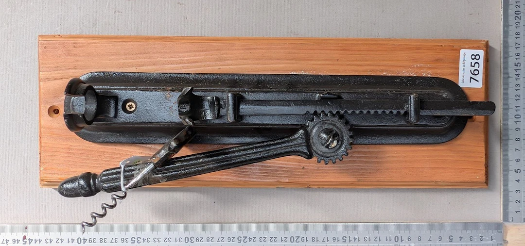 1 antique corkscrew on a wooden base—see photos for dimensions and condition