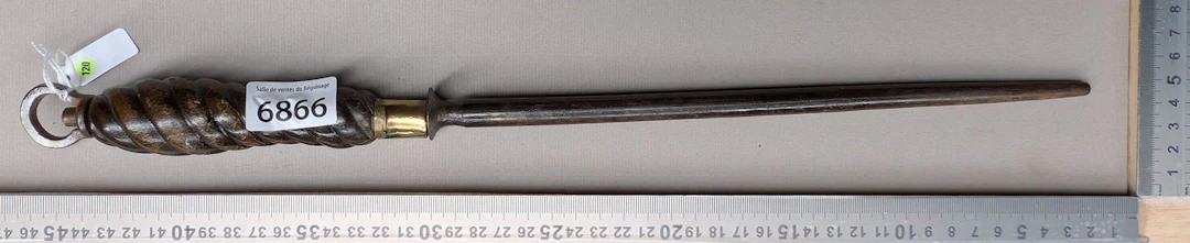 Antique butcher's sharpening knife with wooden handle, 20th century—see