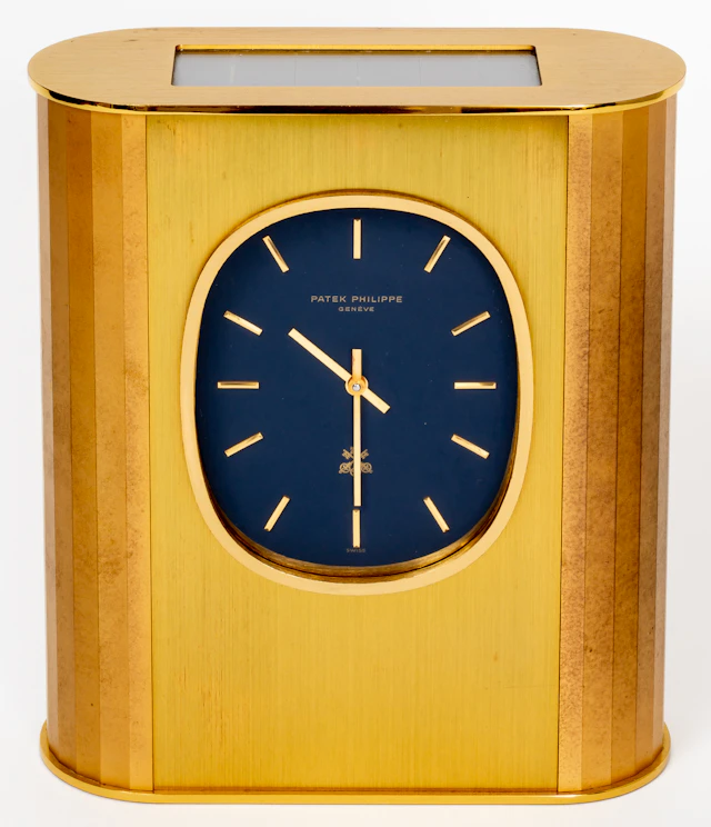 Lot 325: PATEK PHILIPPE "GOLDEN ELLIPSE" SOLAR TABLE CLOCK