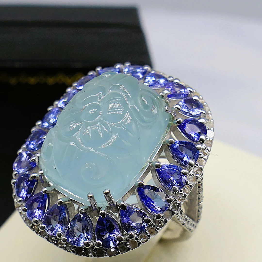 CARVED AQUAMARINE HALO RING.