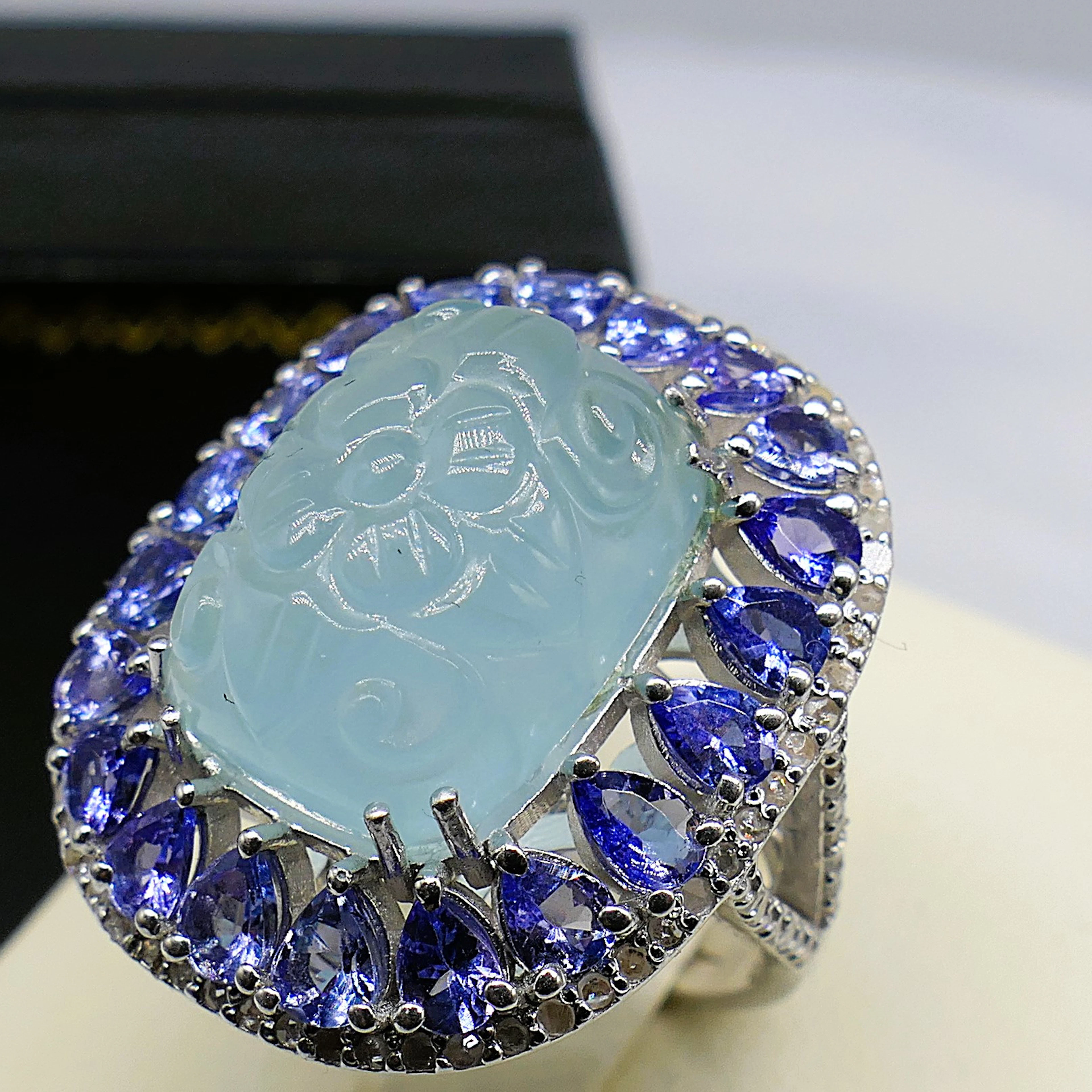 CARVED AQUAMARINE HALO RING.
