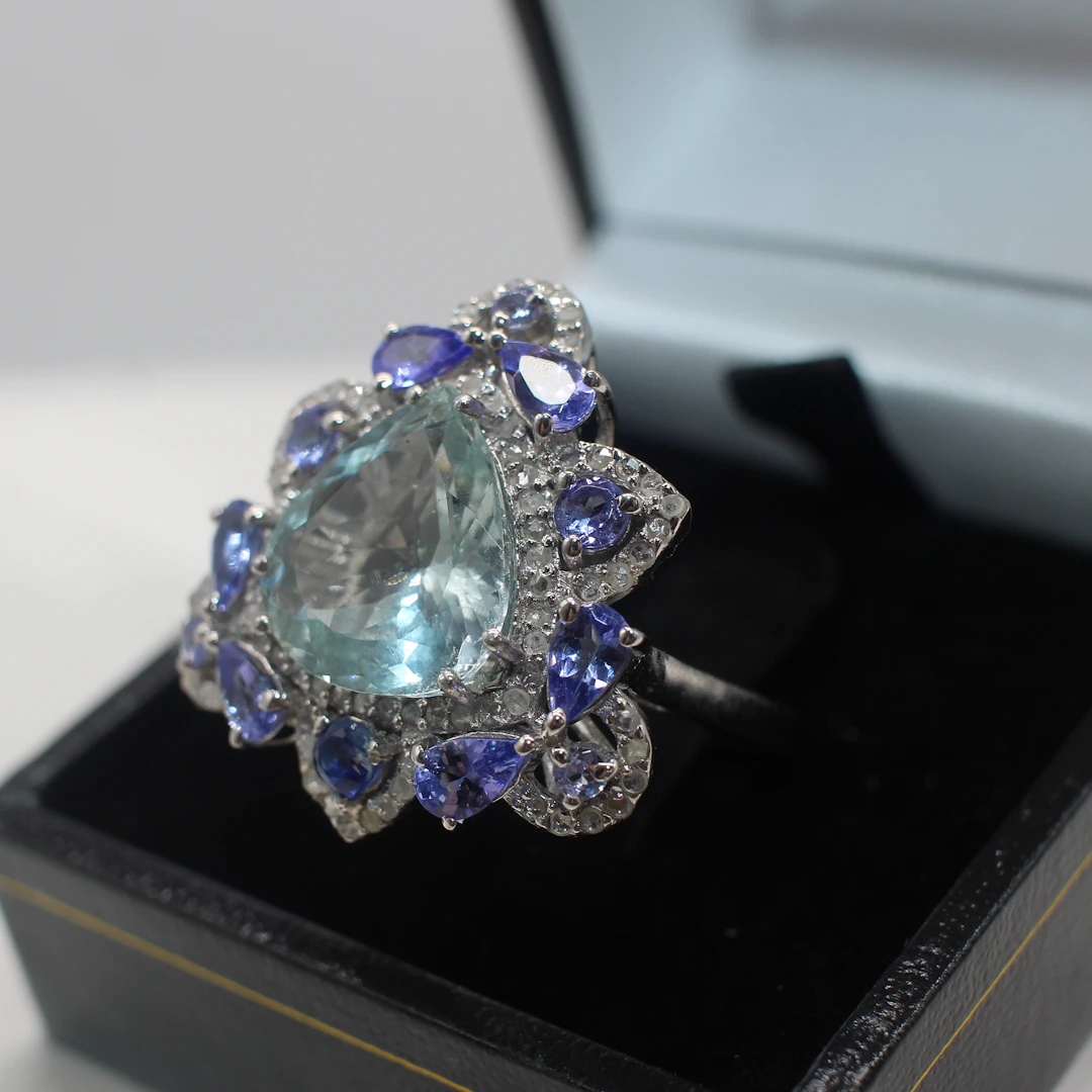 AQUAMARINE, TANZANITE, KYANITE & DIAMOND RING.
