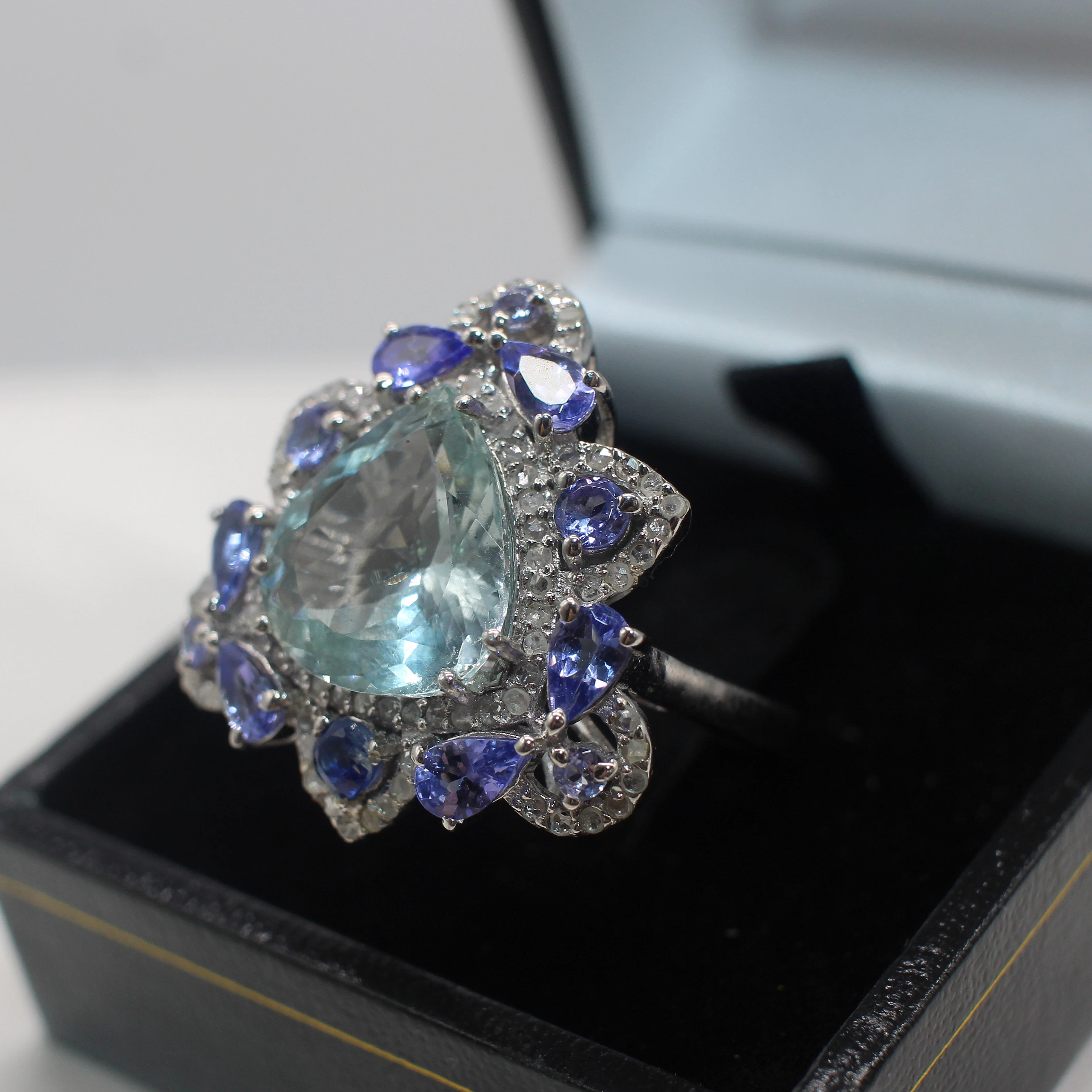 AQUAMARINE, TANZANITE, KYANITE & DIAMOND RING.
