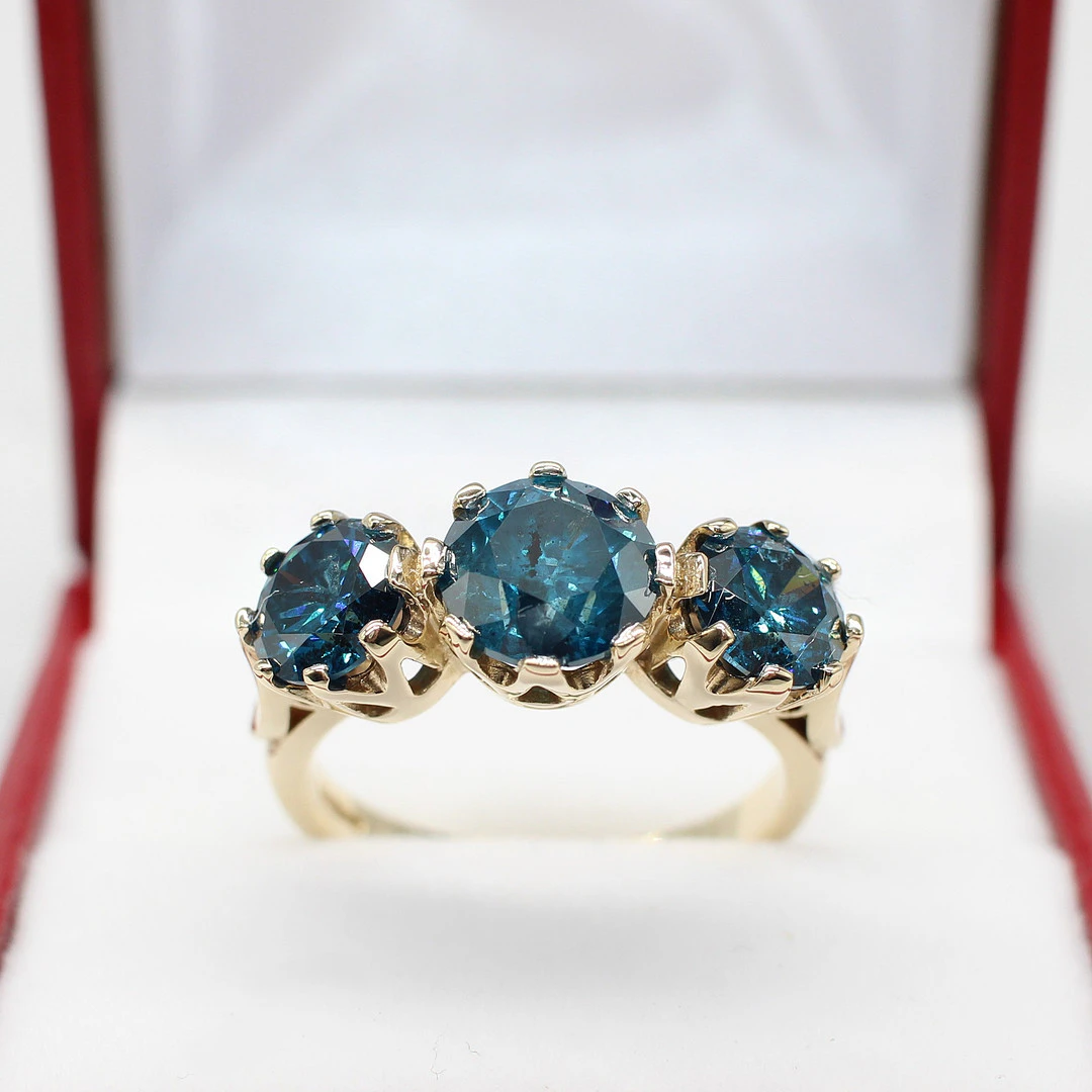FANCY BLUE DIAMOND TRILOGY RING.
