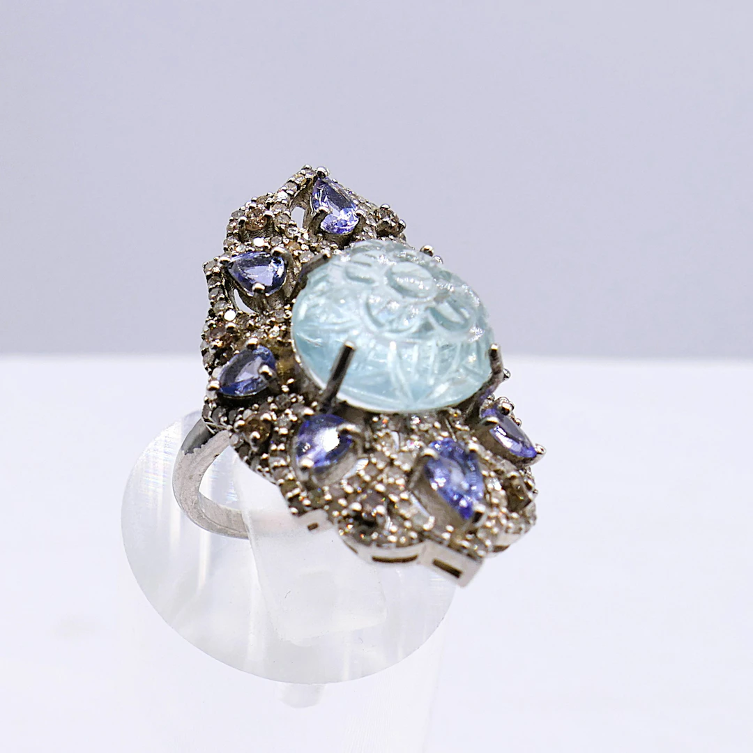 SILVER DRESS RING CARVED AQUAMARINE AND FILIGREE.