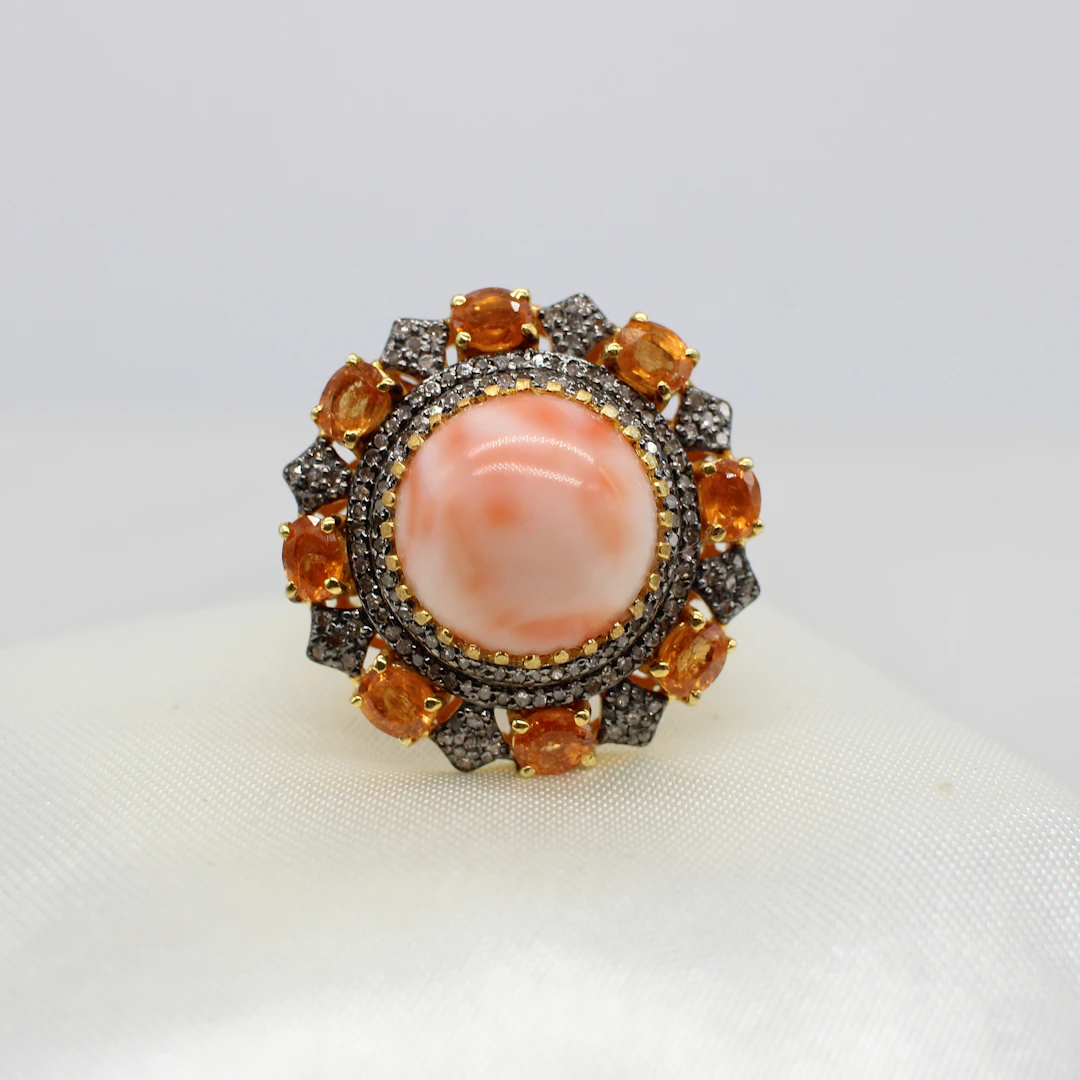 LARGE CORAL, SPESSARTITE & DIAMOND RING.