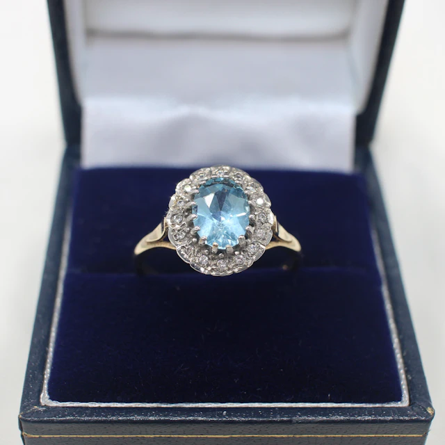 BLUE TOPAZ & DIAMOND CLUSTER RING.