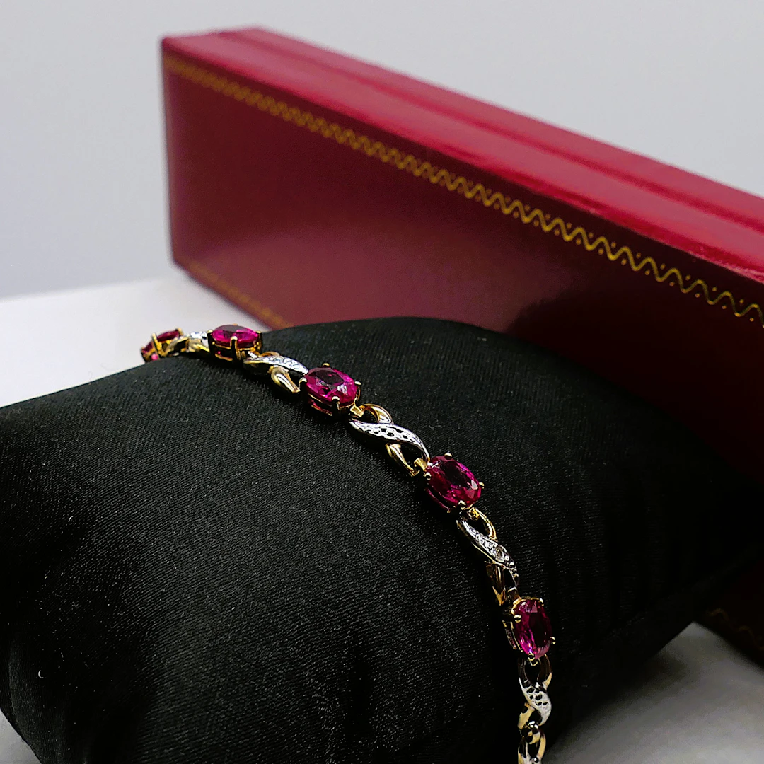 YELLOW GOLD BRACELET SET WITH CREATED OVAL RUBIES AND DIAMONDS.