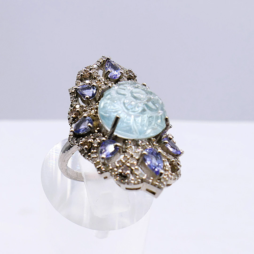 SILVER DRESS RING CARVED AQUAMARINE AND FILIGREE.