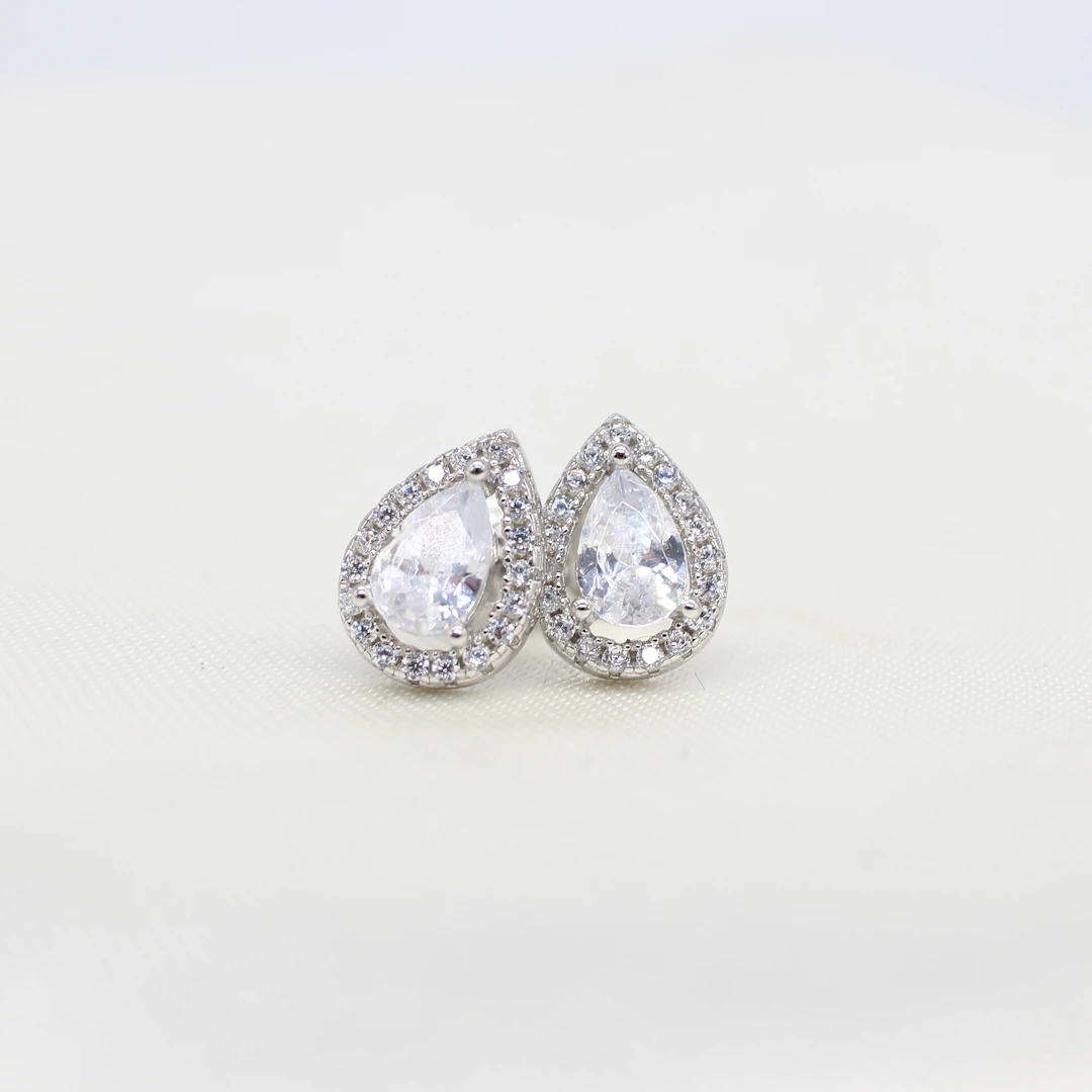 SILVER PEAR SHAPED HALO STUDS.