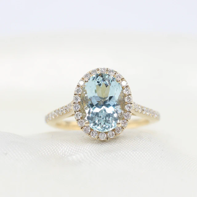 AQUAMARINE & DIAMOND HALO RING.