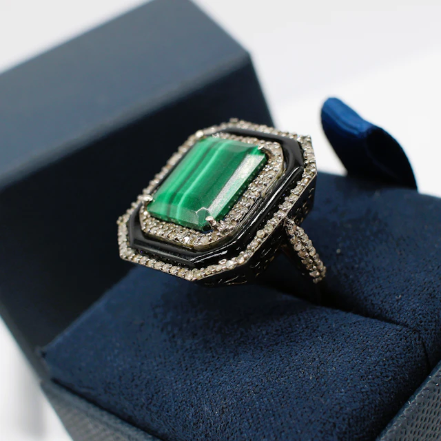 MALACHITE, ONYX & DIAMOND RING.