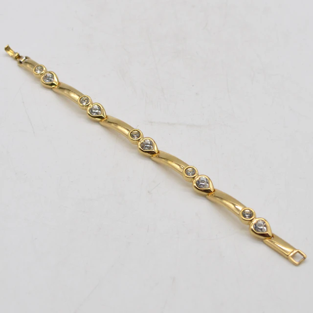 GROSSÉ, VINTAGE MODESCHMUCK, VERGOLDETES GLIEDERARMBAND MIT STRASSSTEINEN