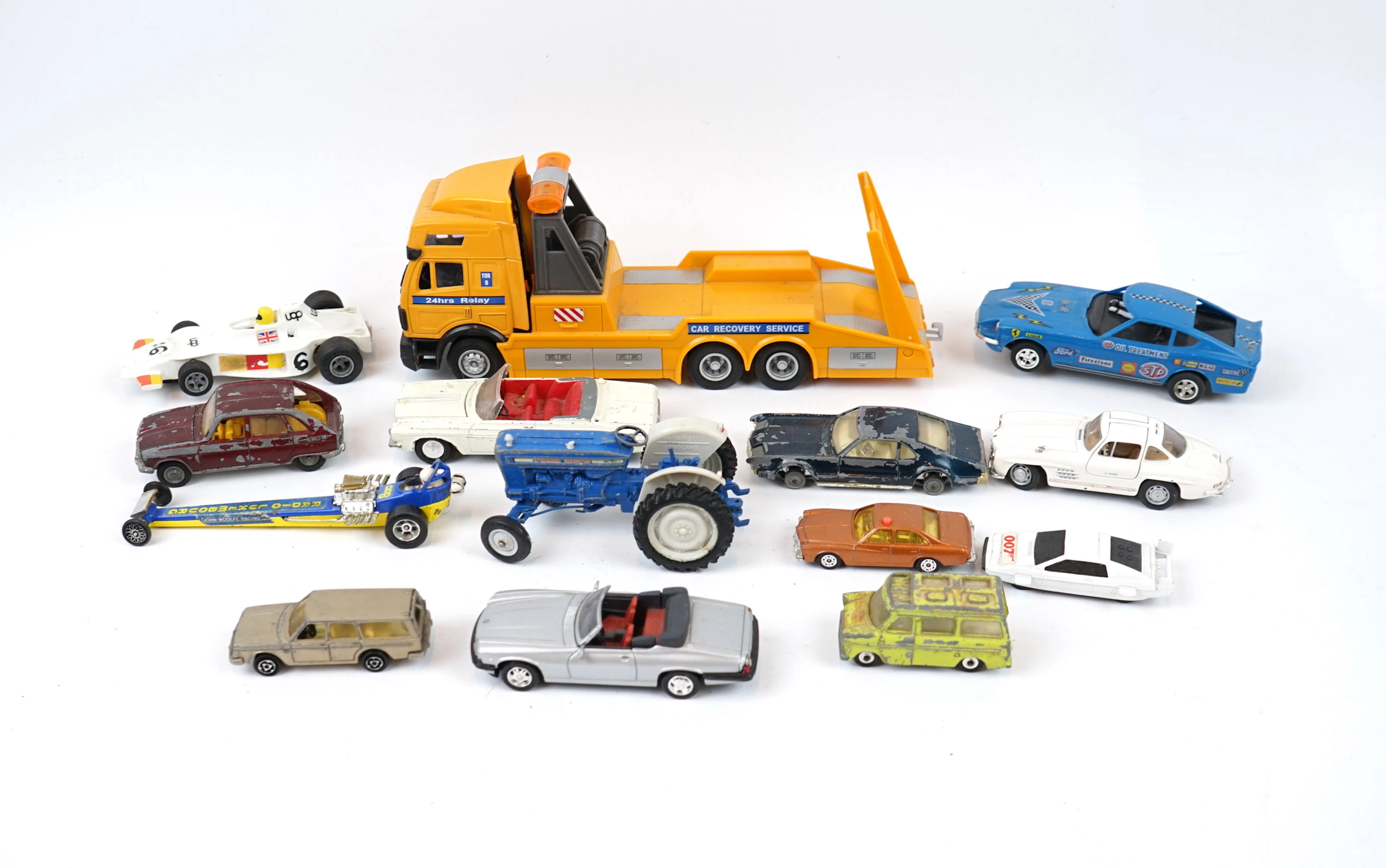 Toy vehicles, a lot, including Corgi and Husky.