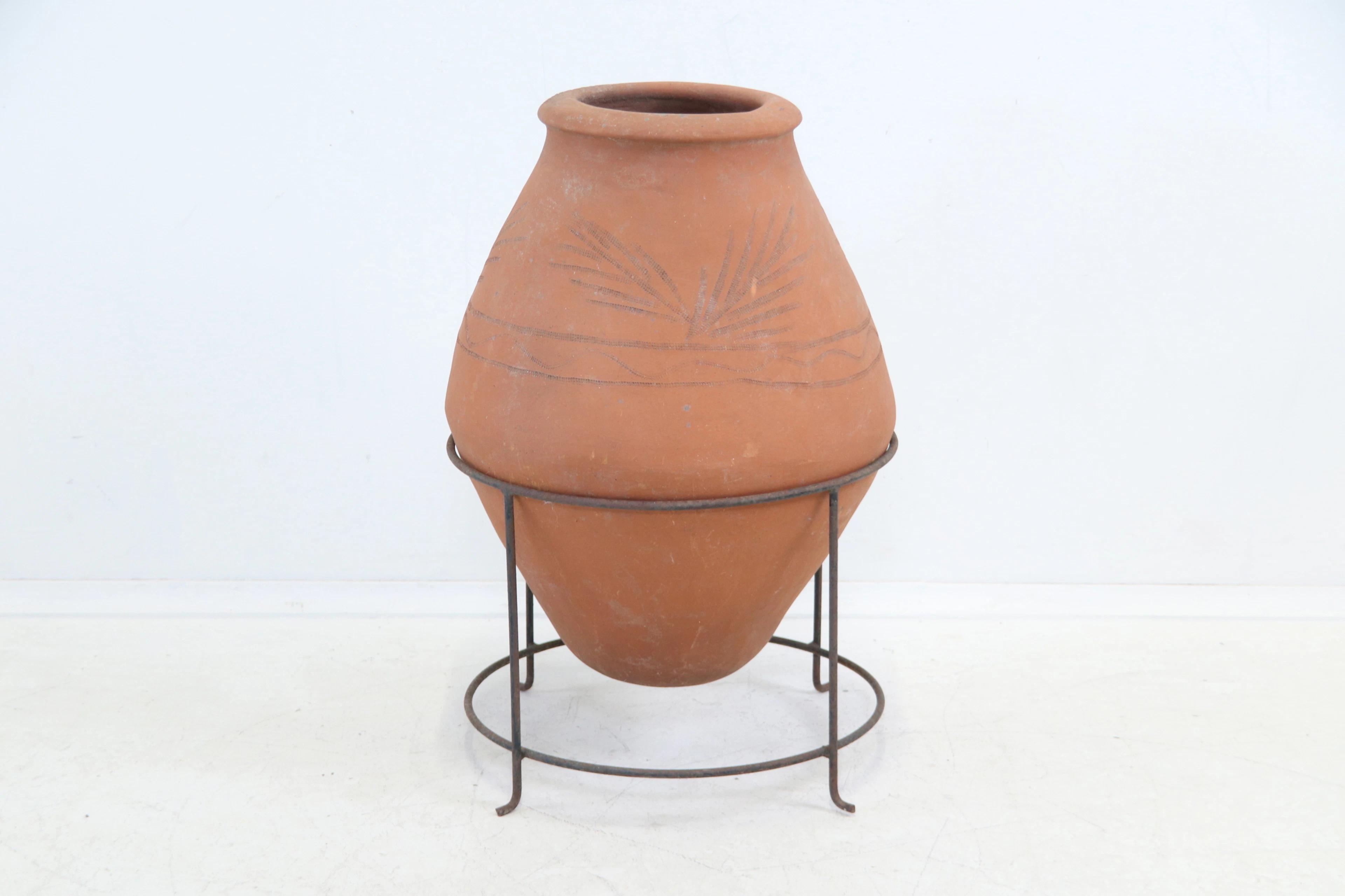 Urn, terracotta, and scaffolding, metal.