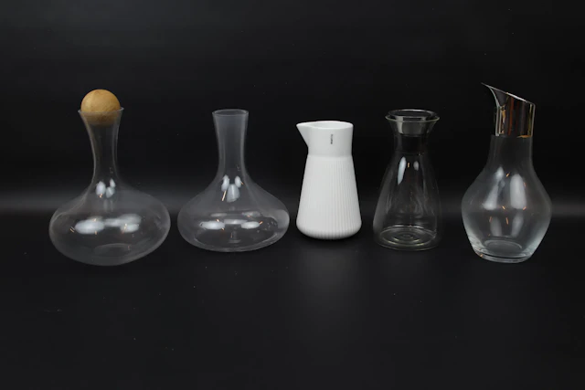 Decanters, 5 pcs, glass/ceramic/metal, including Georg Jensen.