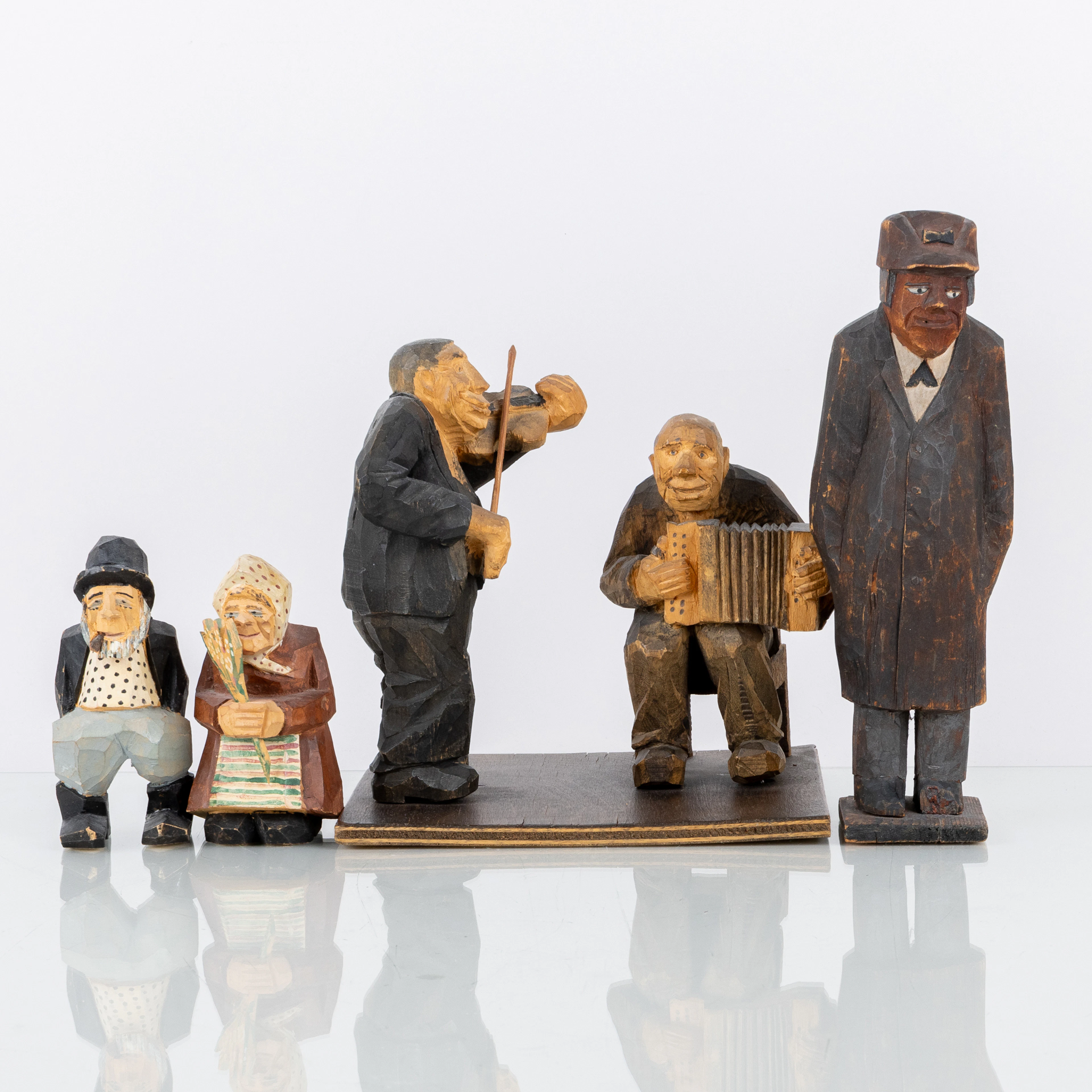 SCULPTURES, 4 pcs, carved and painted wood, including Midas Karlson, 1900s